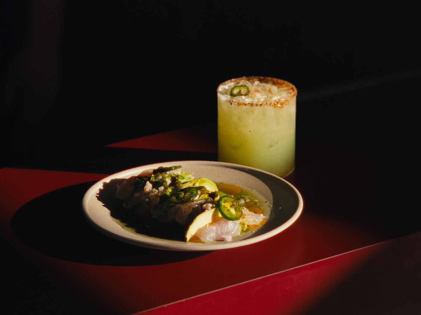 Spicy margarita and a ceviche plate on the red bar at MULE